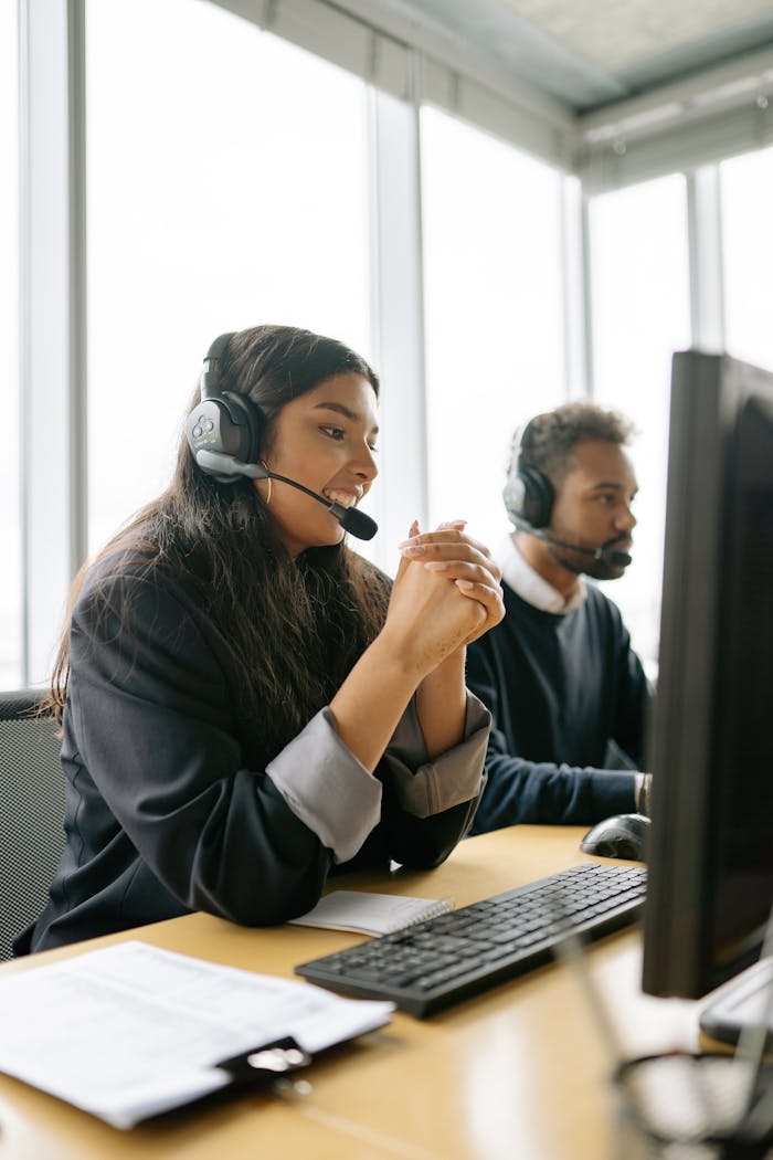 About Customer service team working in a modern office with headsets.